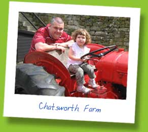 My Husband and daughter playing on a tractor at Chatsworth Farm